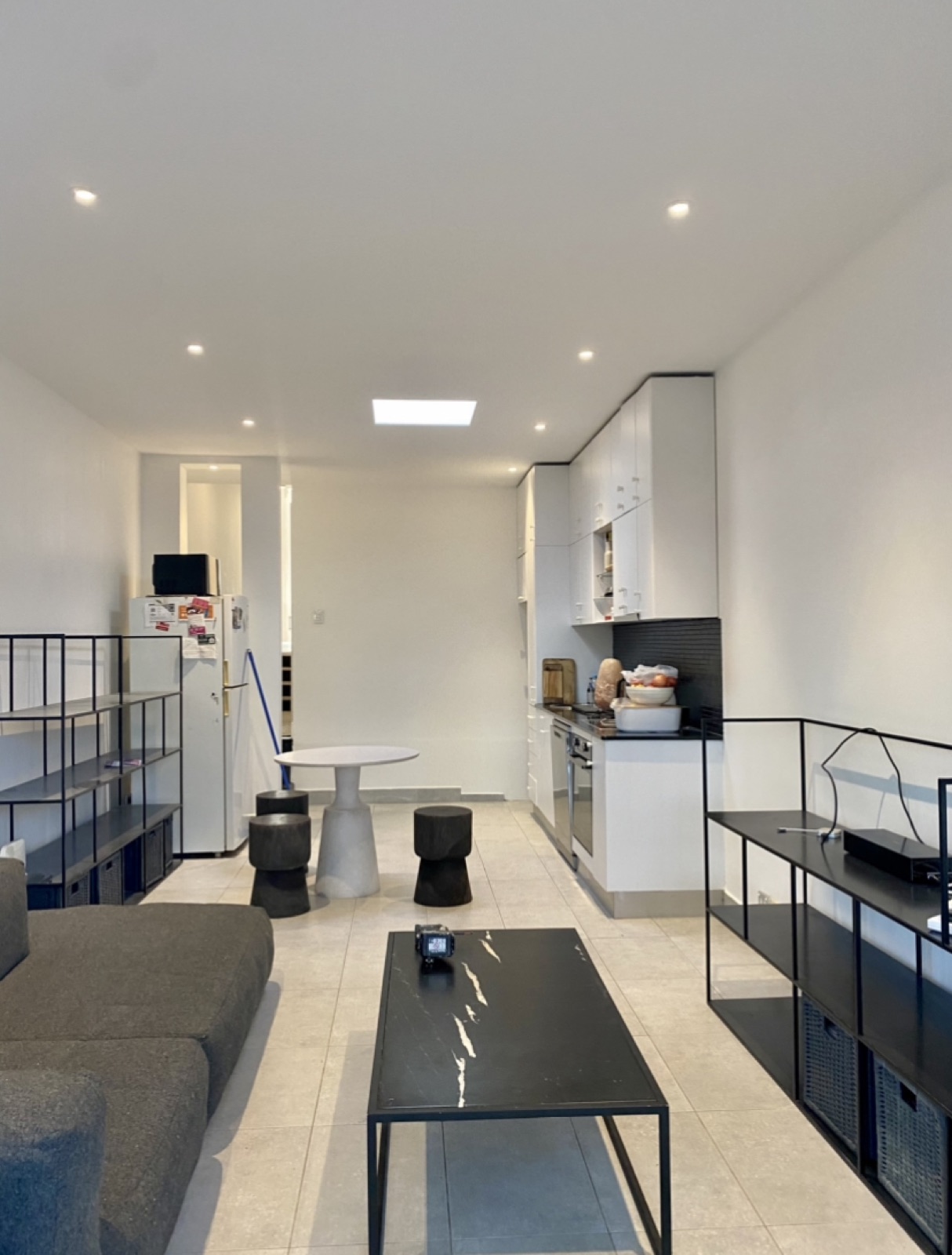 Freshly painted white open-plan apartment living area