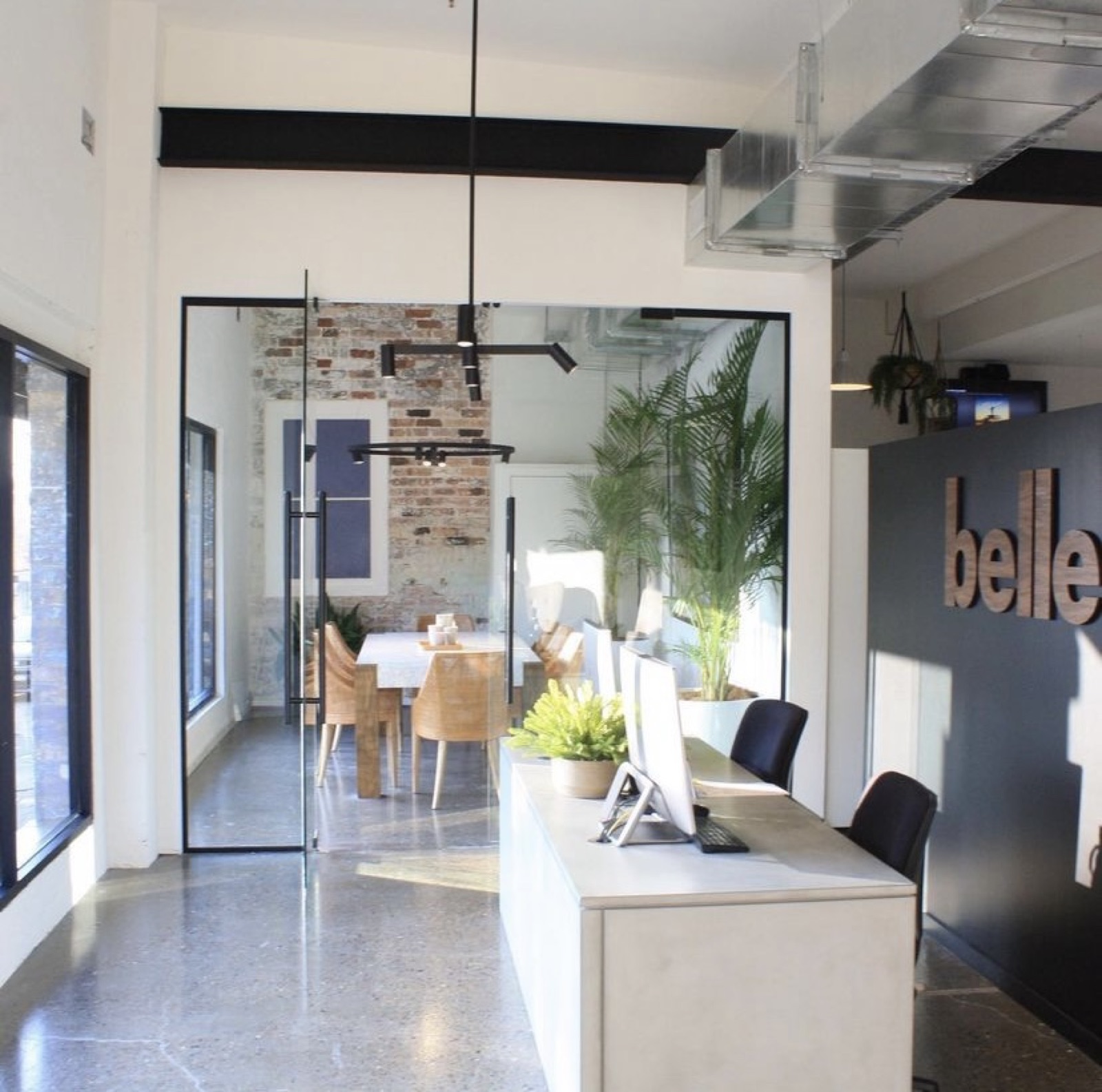 Office reception with exposed brick and glass partition