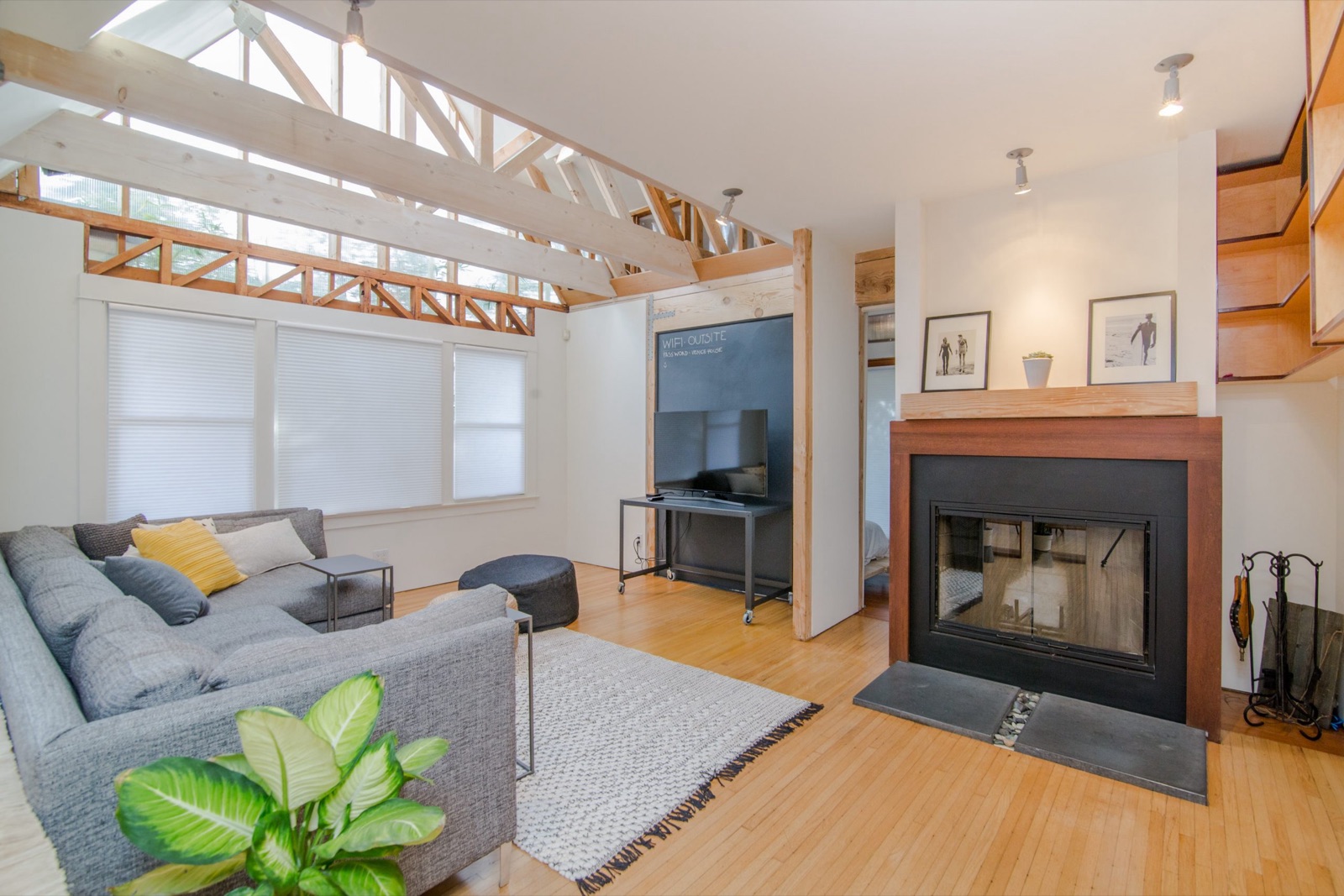 Open-plan living room with exposed timber roof trusses